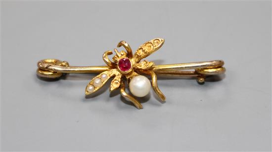 A late Victorian yellow metal ruby, cultured and seed pearl set bug brooch, 28mm, gross weight 1.6 grams.